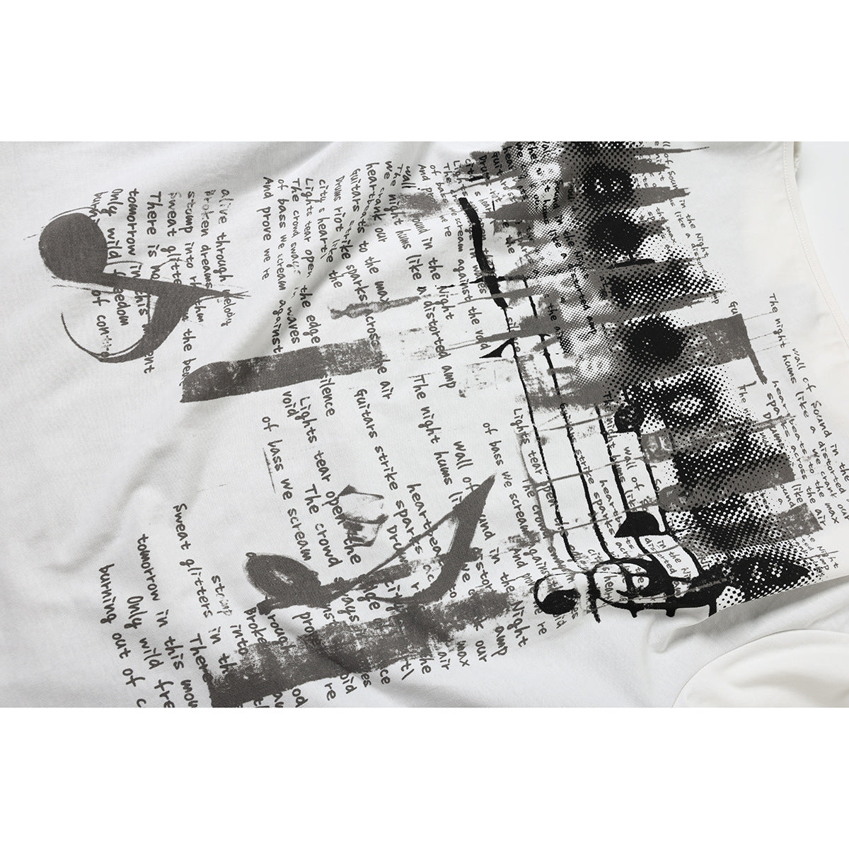 Close-up of a white shirt covered with a black and gray abstract graphic and handwritten-style English text.