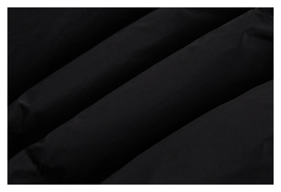 Close-up of black padded fabric with broad stitched channels.