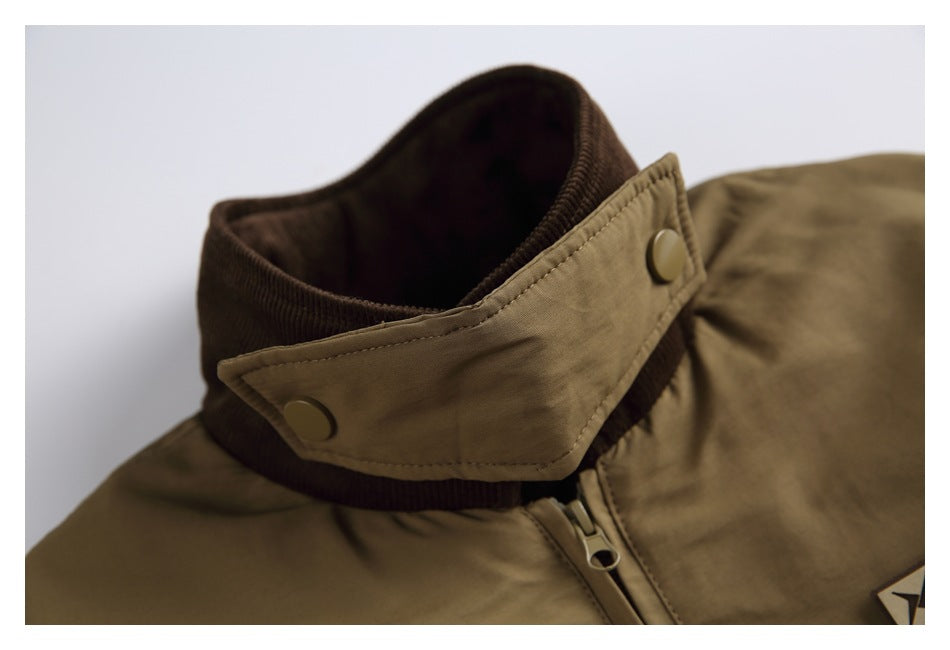 Close-up of an olive-brown jacket collar with a dark ribbed inner band, snap-tab closure and front zipper.