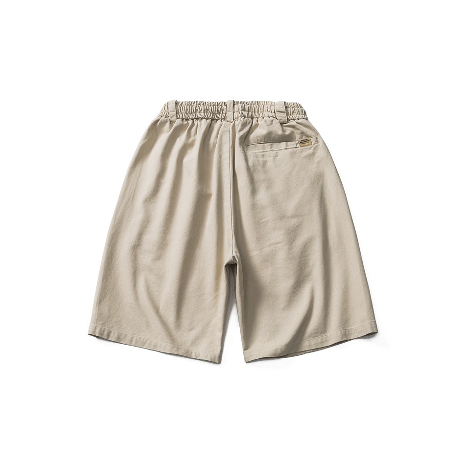 Back view of light khaki shorts with elastic waistband, back welt pocket and small tag