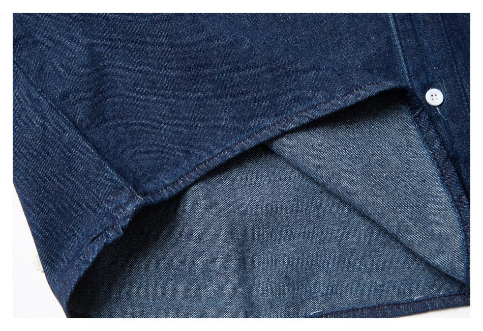 Close-up of the shirt sleeve opening, showing stitching and the lighter reverse side of the fabric.