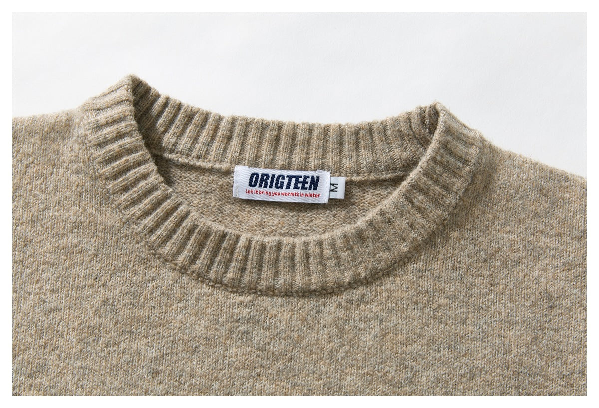 Close-up of the beige sweater’s ribbed crewneck and sewn-in neck label.
