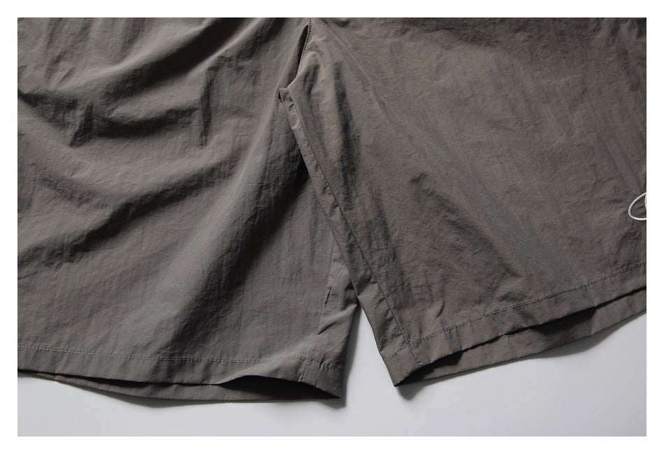 Close-up of the shorts' leg hems and side slit.