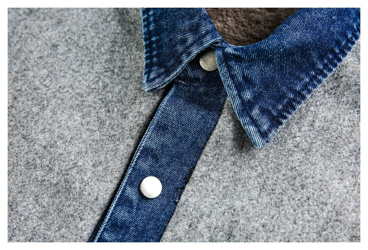 Close-up of a blue denim collar and snap-button placket against gray jacket fabric.