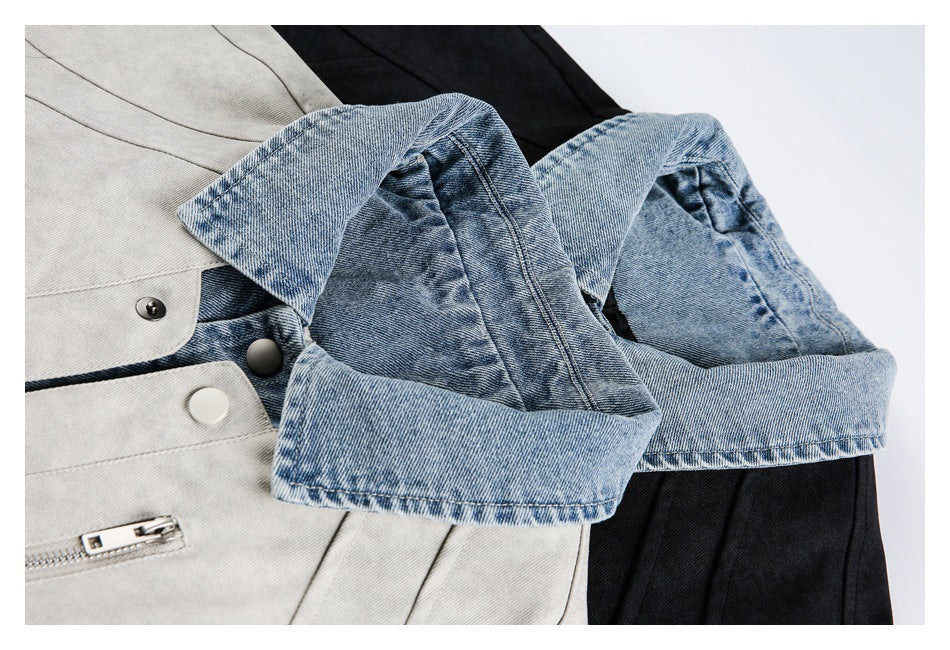 Close-up of light gray and black jackets showing blue denim cuffs, snap buttons, and a zip pocket.