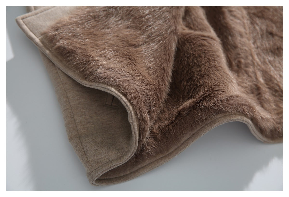 Close-up of the plush brown lining and bound edge of a beige coat.