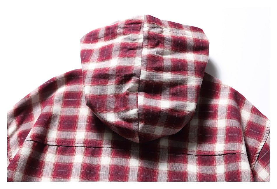 Rear view of a red, burgundy, and cream plaid shirt with a hood and a horizontal back seam.
