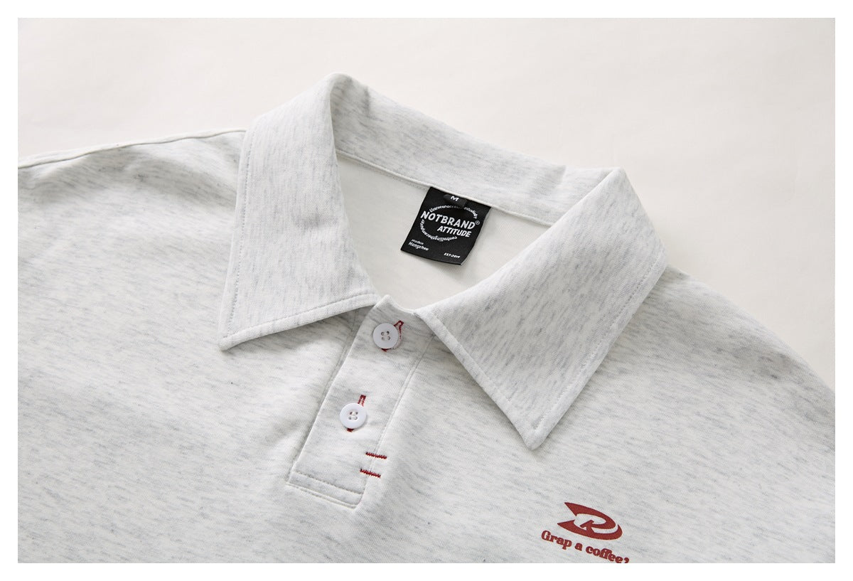 Close-up of a light gray heather polo shirt collar, button placket, and small red chest logo.