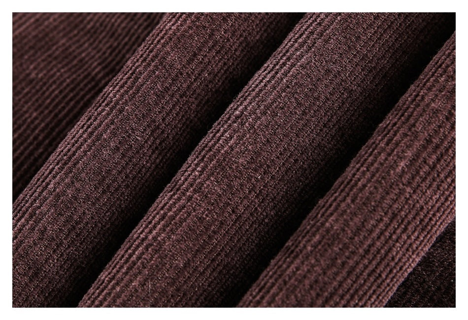 Close-up of folded dark brown ribbed fabric showing its textured surface.