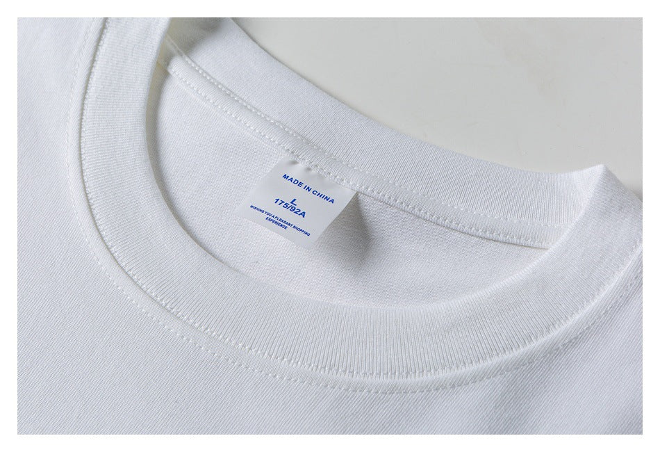 Close-up of a white T-shirt collar and inner label marked “Made in China” with small blue text.