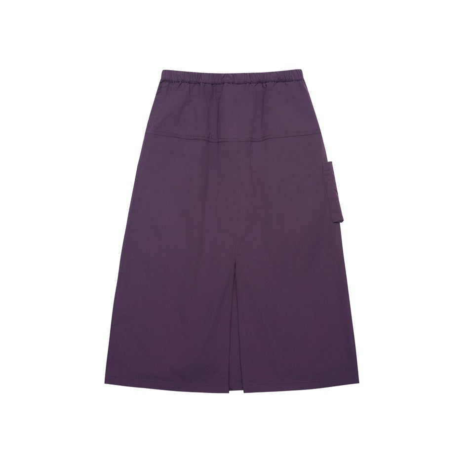 Back view of a dark purple long skirt with an elastic waist, side pocket, and center slit.