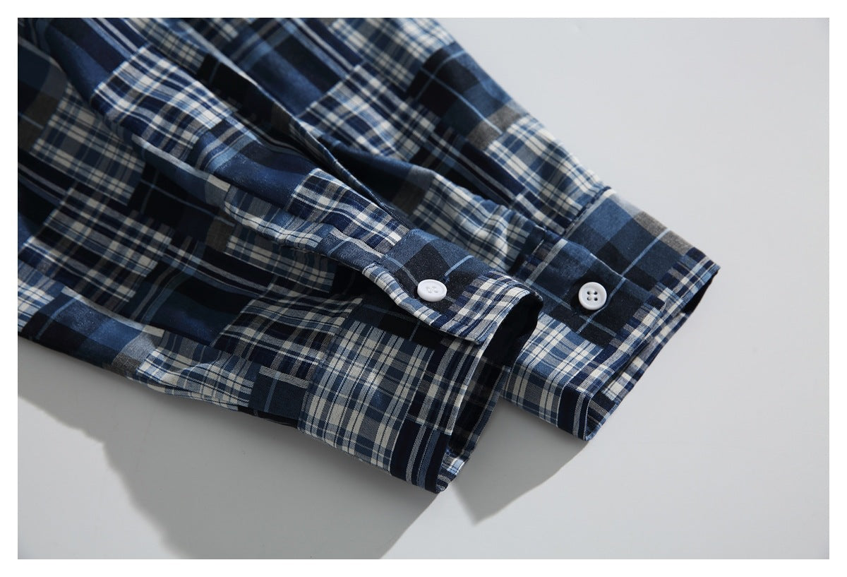 Close-up of the plaid shirt's buttoned sleeve cuffs.