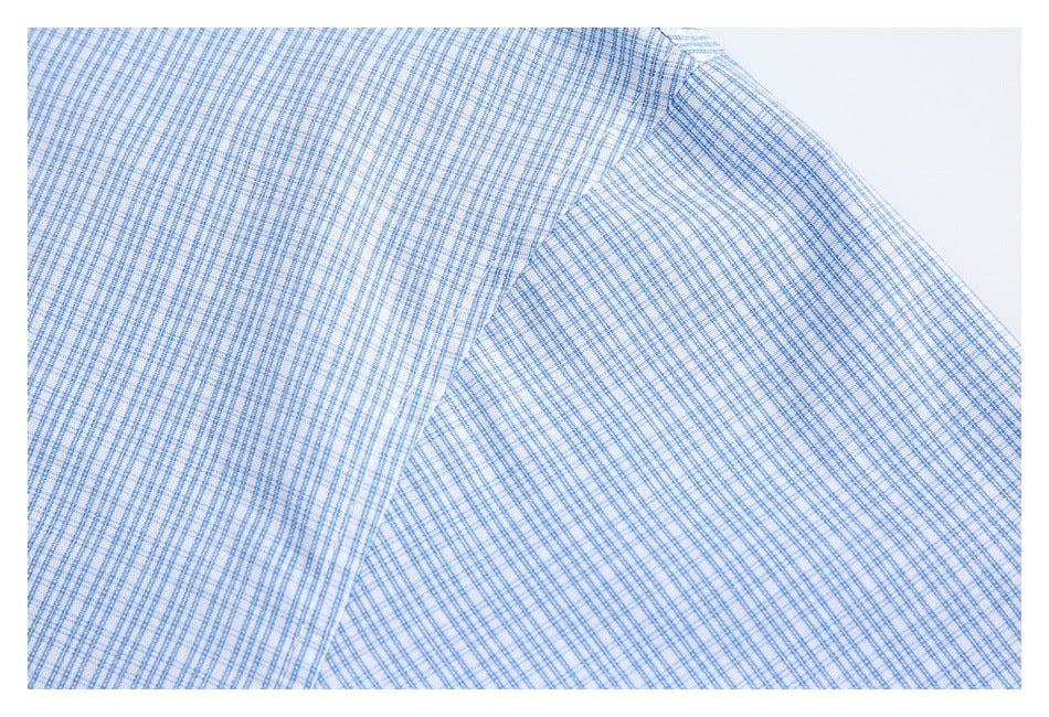 Close-up of the light blue check fabric and a stitched seam.