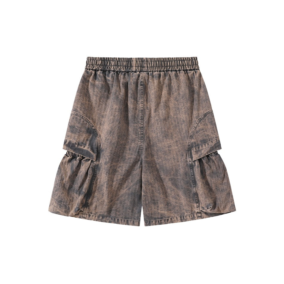 Back of grey-brown washed cargo shorts with elastic waistband and side cargo panels with gathered lower sections