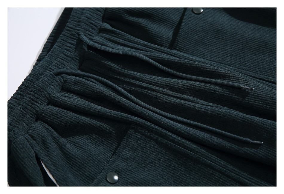 Close-up of the pants' elastic waistband, drawstrings, and snap-button pockets.