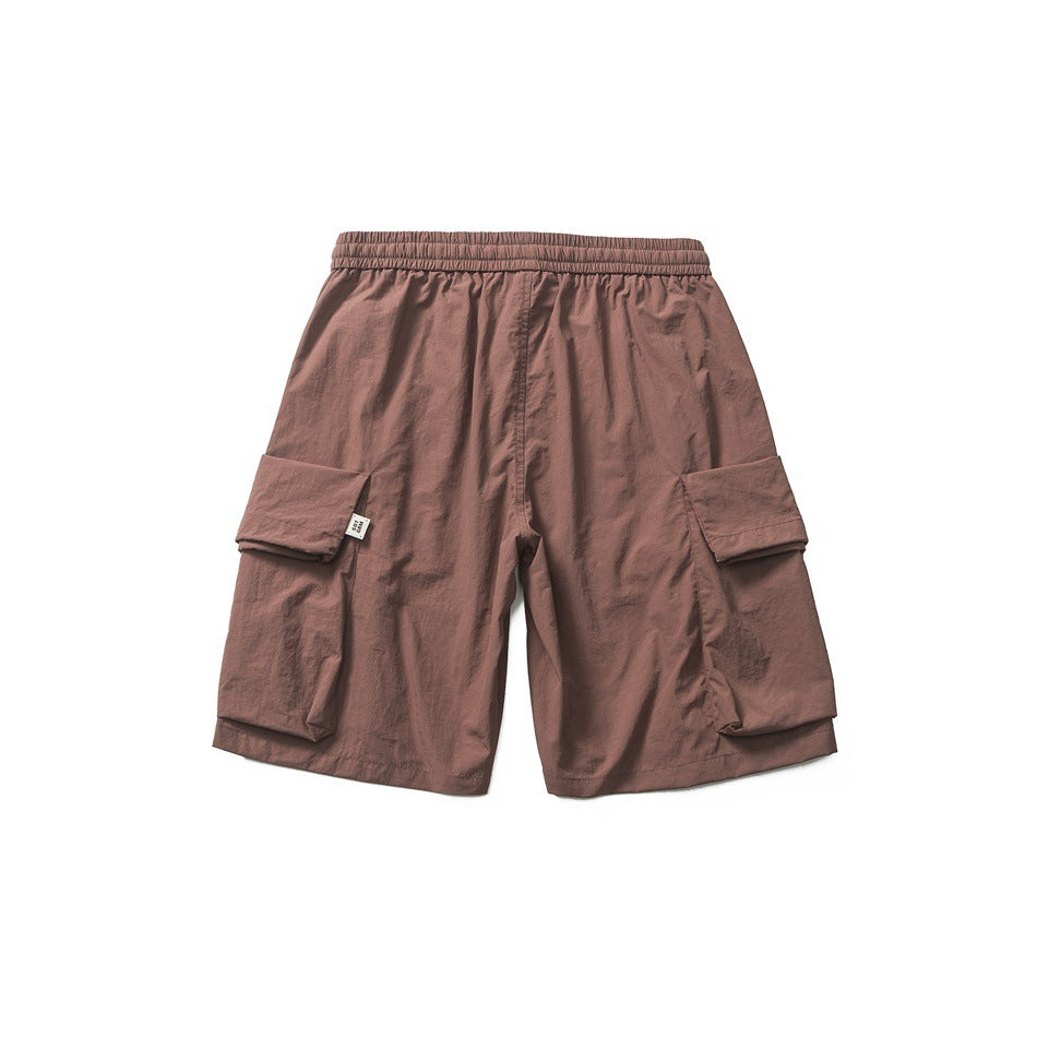 Back view of reddish-brown cargo shorts with elastic waistband and large flap pockets on the sides