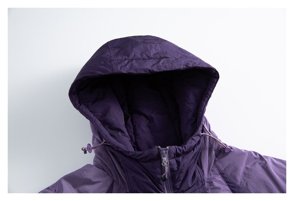 Close-up of a purple jacket's hood, drawcords, and upper front zipper.