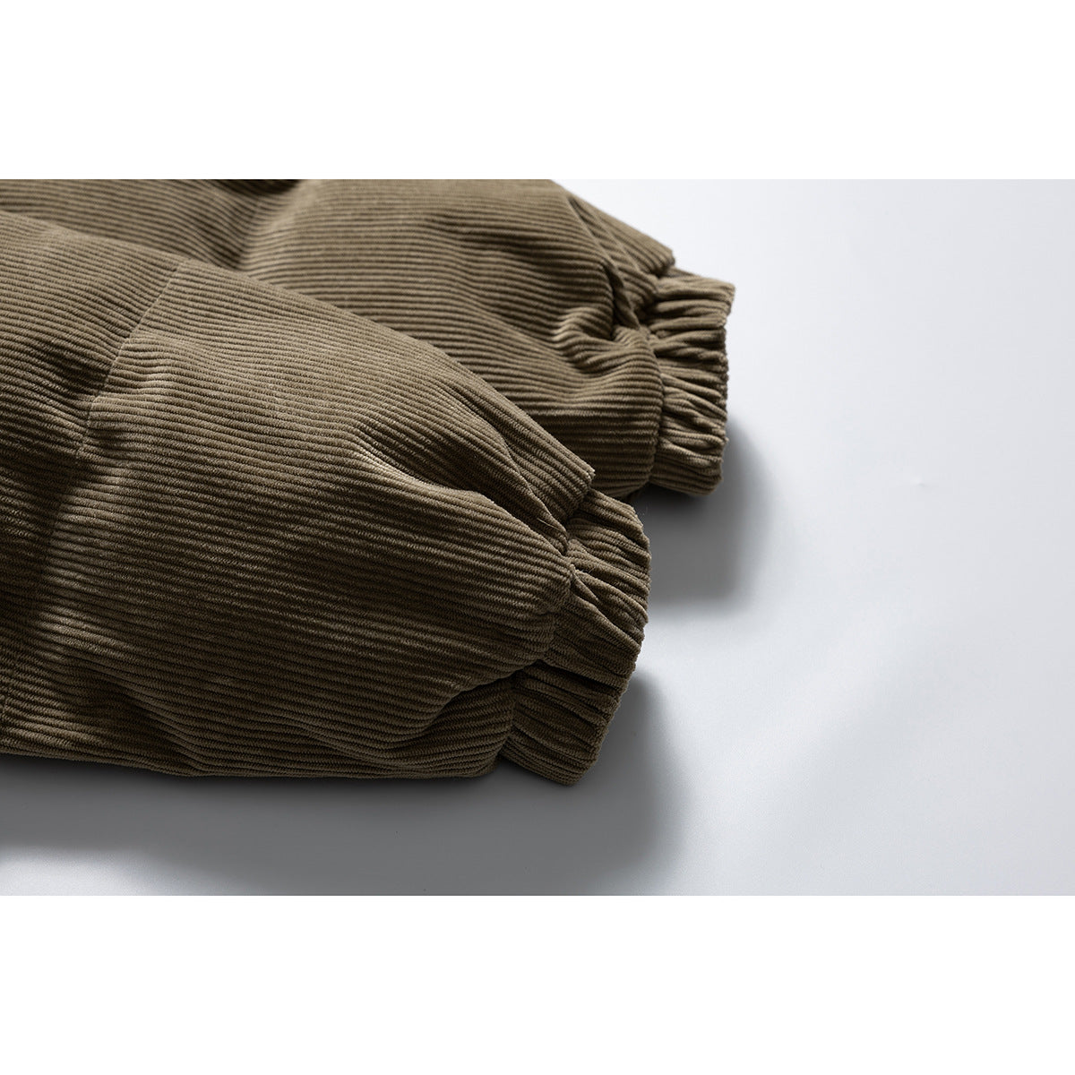 Close-up of the olive-brown jacket’s gathered elastic cuffs and ribbed sleeves.