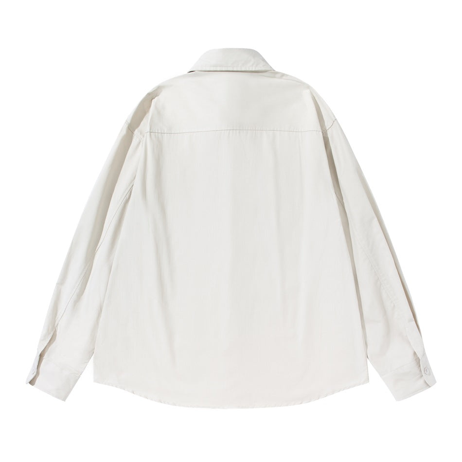 Beige long-sleeve shirt back view showing yoke seam and buttoned cuffs, flat lay