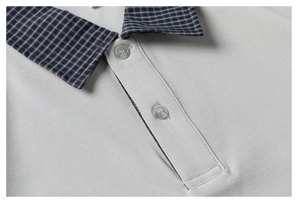Close-up of the gray polo's two-button placket and navy checked collar.