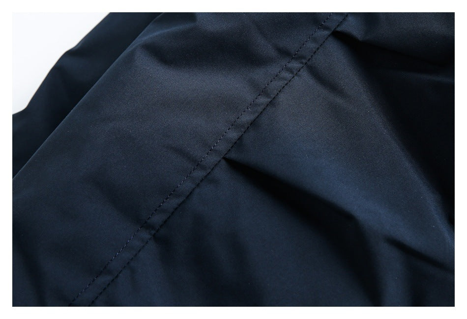 Close-up of a diagonal stitched seam on dark navy garment fabric.