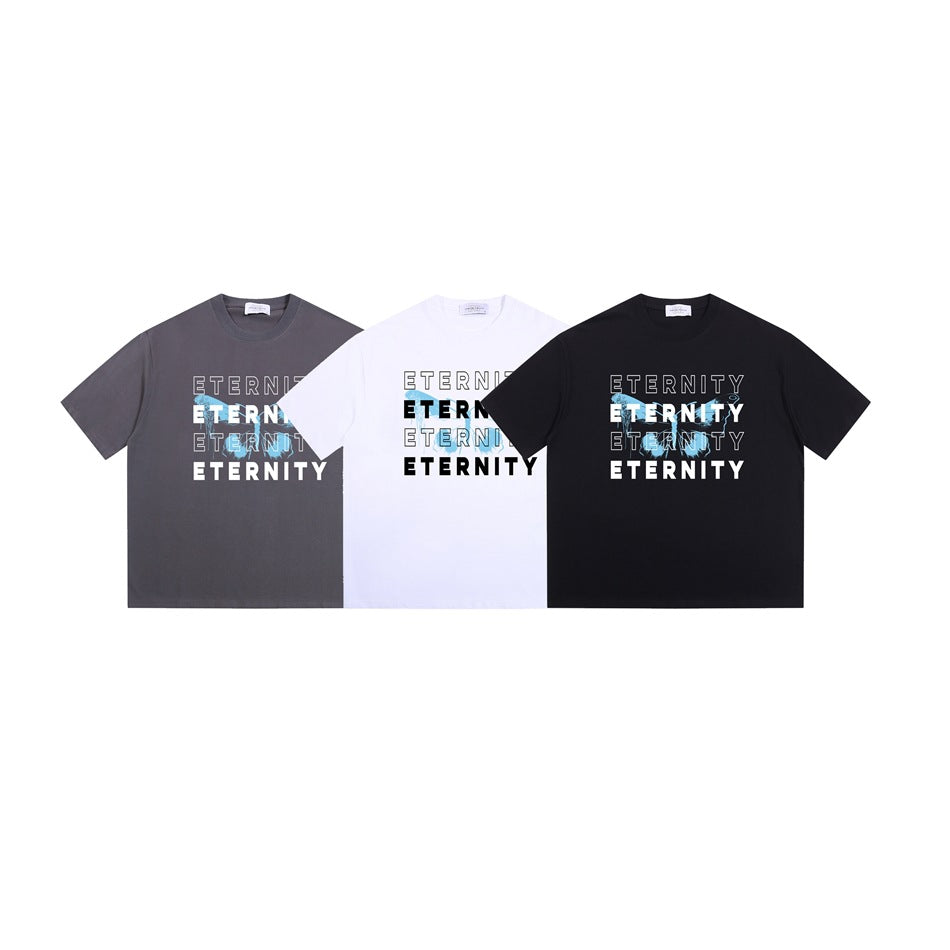 Three front-view graphic T-shirts in charcoal gray, white, and black, each printed with “ETERNITY.”