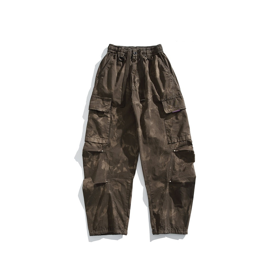 Front view of dark brown cargo pants with an elastic drawstring waist, large side pockets and elastic cuffs.