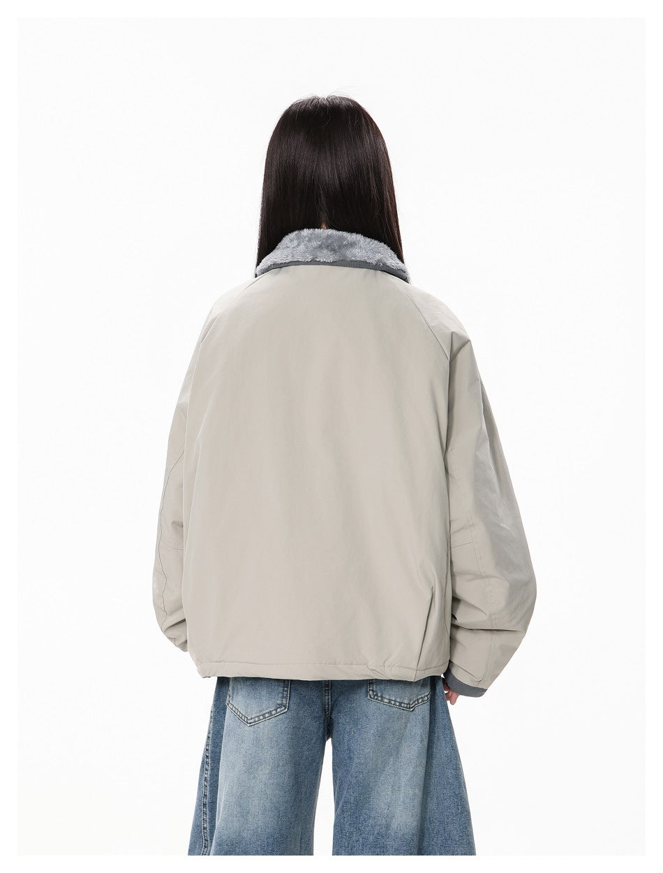 Rear view of a model wearing the light gray jacket with a plush gray collar.