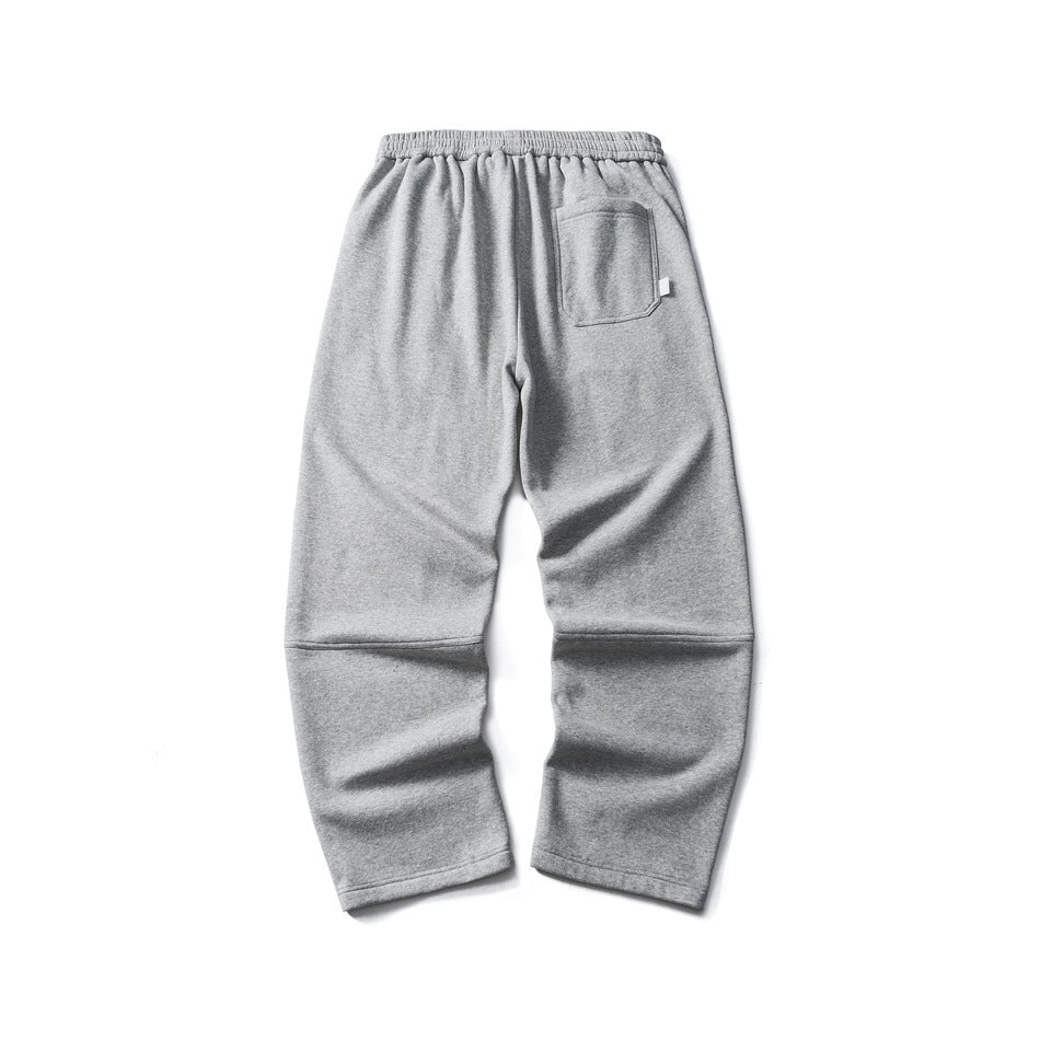 Back view of heather gray sweatpants with elastic waistband, back patch pocket and seamed knee panels