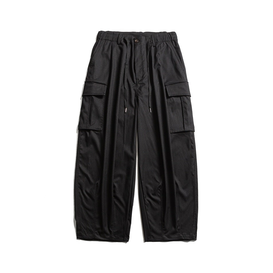 Black wide-leg cargo pants with elastic drawstring waist and large flap cargo pockets, front view