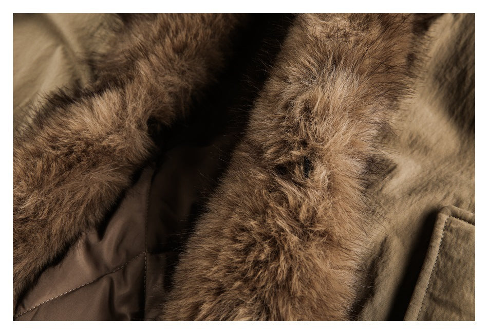 Close-up of the coat’s thick brown fur trim beside its tan outer fabric.