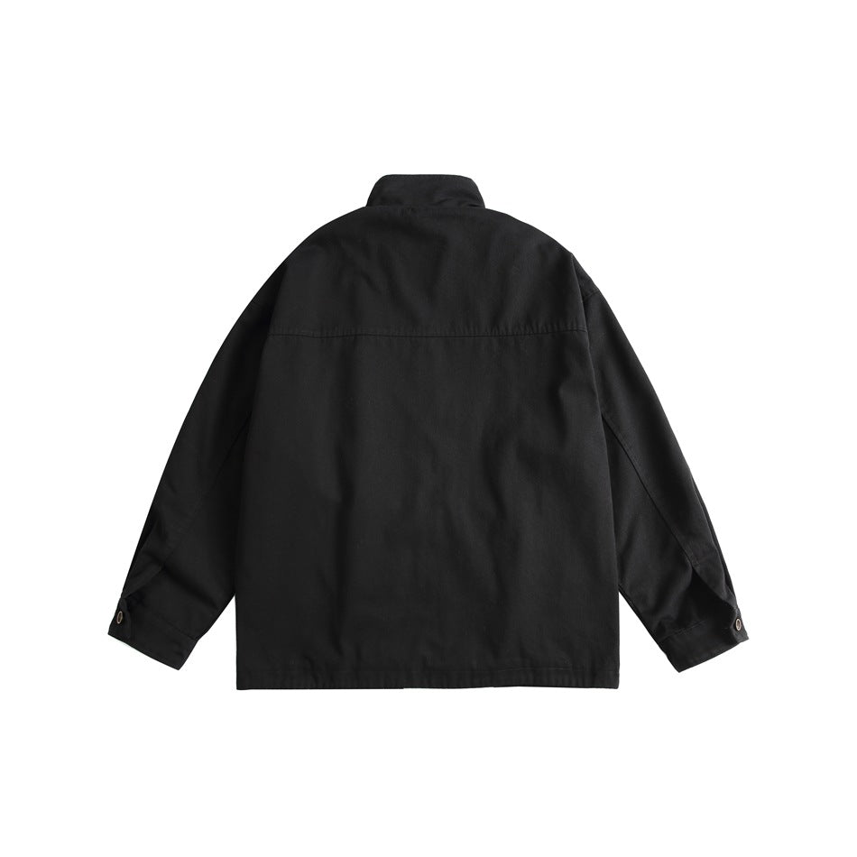 Back view of black stand-collar jacket with yoke seam and button cuffs