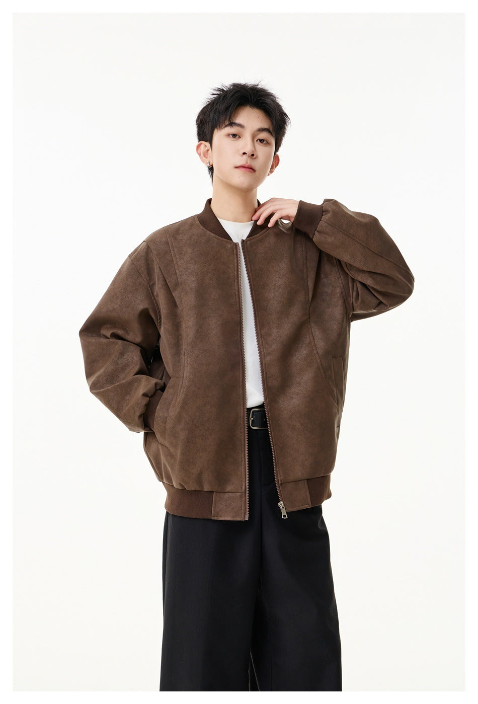 Front view of a model wearing a brown zip-front bomber jacket with ribbed trim and front pockets.