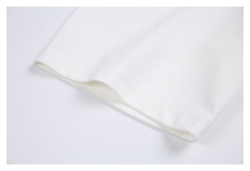 Close-up of the white T-shirt sleeve hem and stitching.