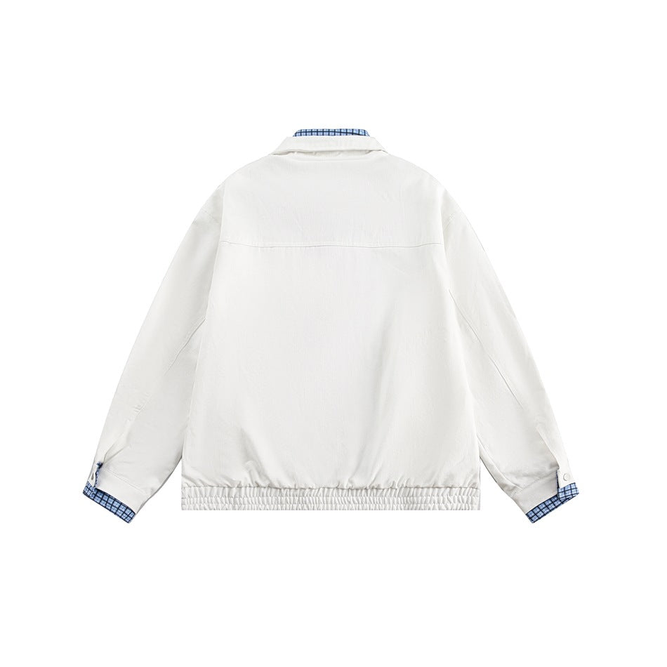 Back view of a white jacket with a gathered hem and blue checked fabric showing at the collar and cuffs.