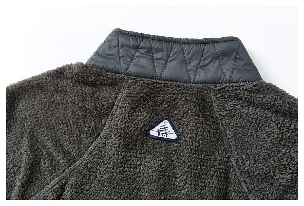 Close-up of the jacket's upper back, with a quilted dark collar panel and a small triangular embroidered patch.