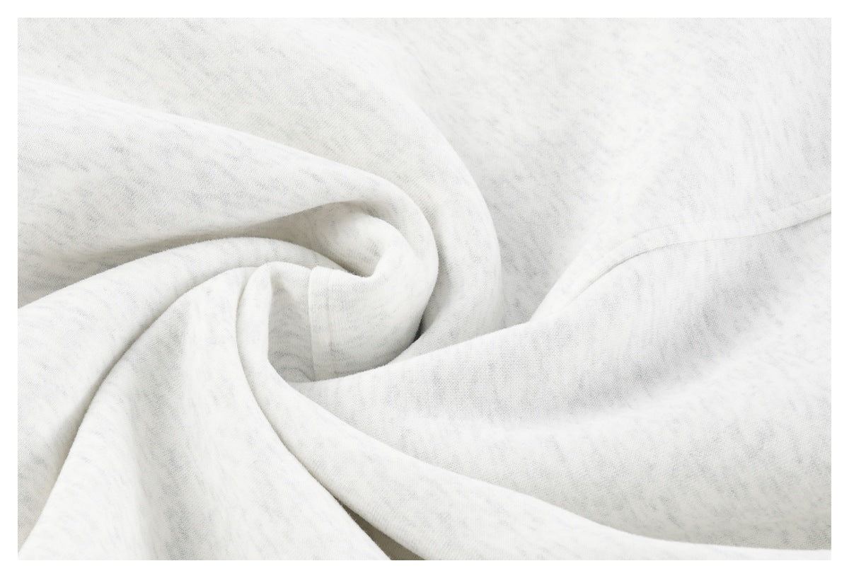 Close-up of light gray sweatshirt fabric gathered into soft folds.