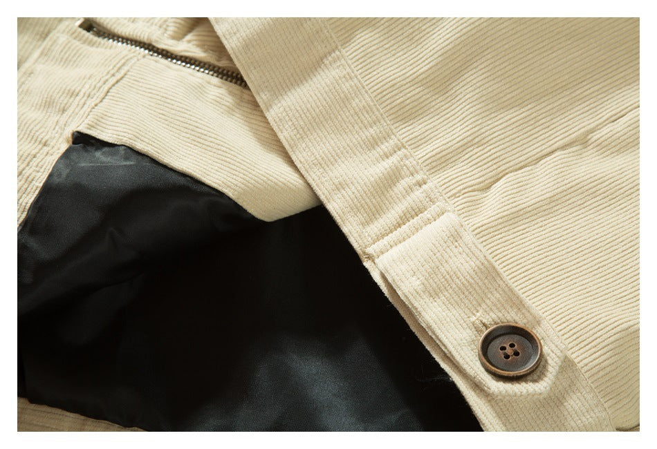 Close-up of the cream jacket's buttoned cuff tab and black inner lining.