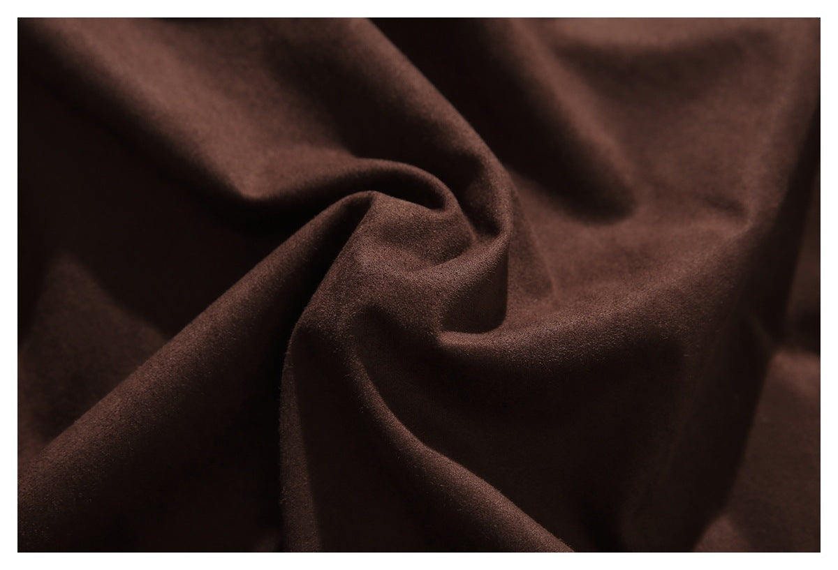 Close-up of dark brown fabric gathered into soft folds.