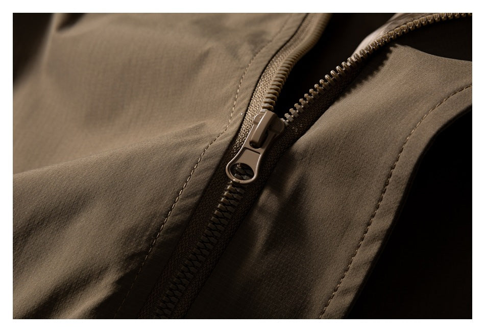 Close-up of the brown jacket's front zipper and stitched panels.