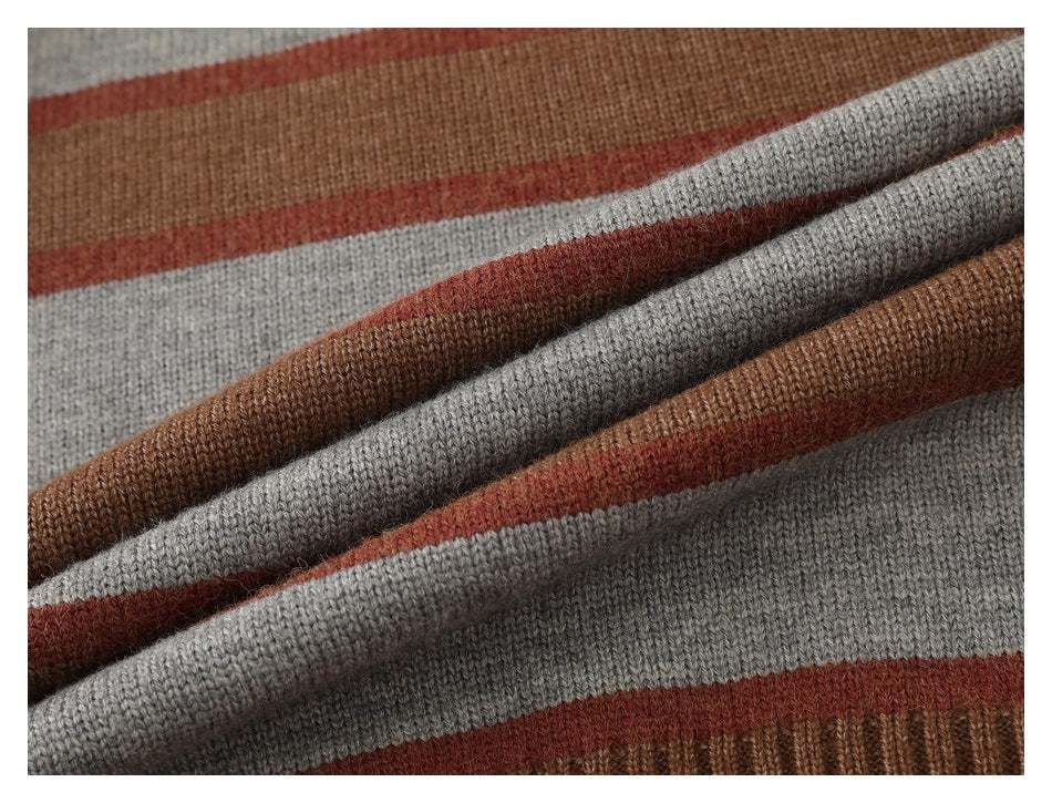 Close-up of folded brown, gray, and rust striped knit fabric showing its texture and layers.