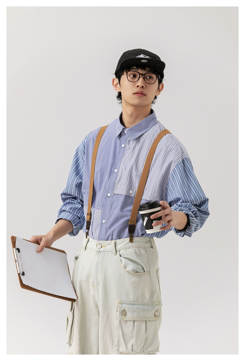 Model wearing a blue-and-white mixed-stripe button-up shirt with a chest pocket and contrast panels.
