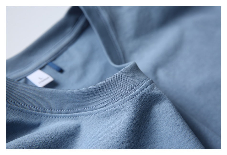 Close-up of a blue crew neckline with ribbed trim and an inside tag.
