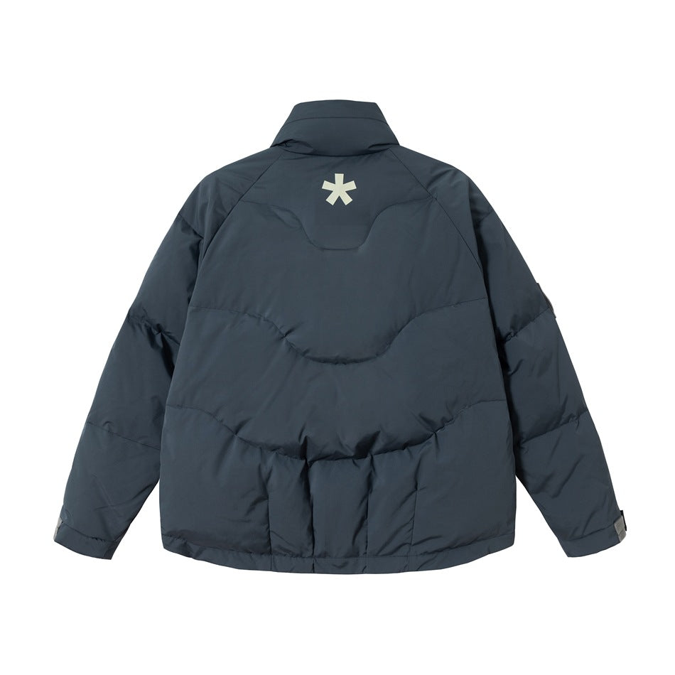 Back view of a dark slate padded jacket with a high collar, curved quilting, and a small pale star-like mark.