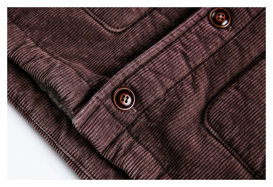 Close-up showing the jacket's plum-brown ribbed fabric, button placket, stitching and brown buttons.