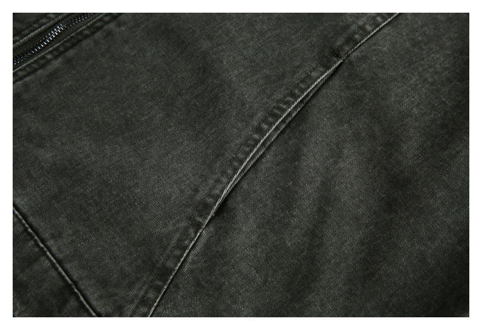 Close-up of the jacket's dark textured fabric and curved panel seam.
