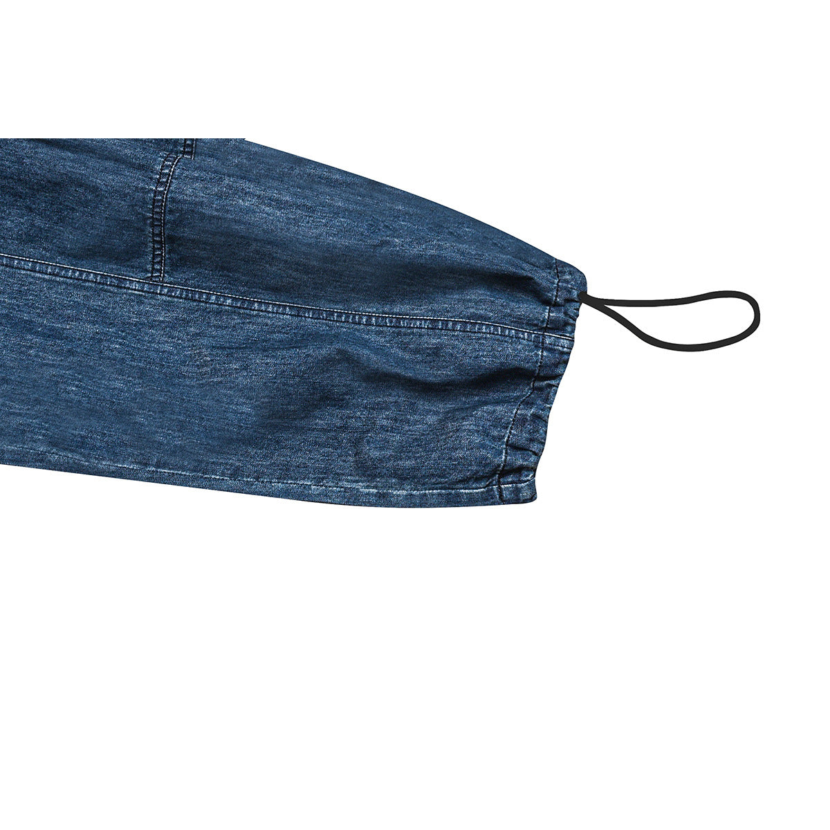 Close-up of a blue denim trouser leg hem with a black loop drawcord and visible contrast stitching.