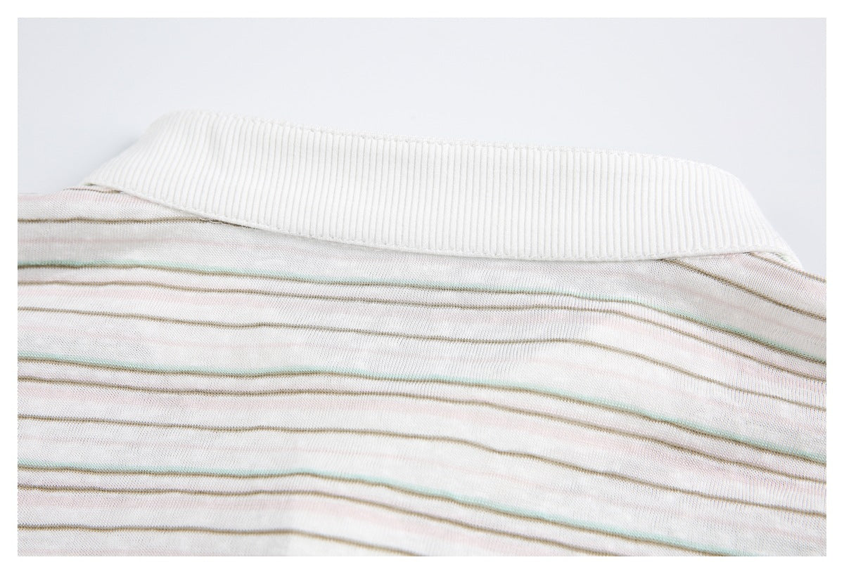Close-up of a ribbed off-white collar on a garment with thin muted multicolor stripes.