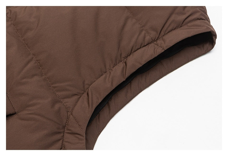 Close-up of a brown garment's curved opening with black trim and stitched panels.