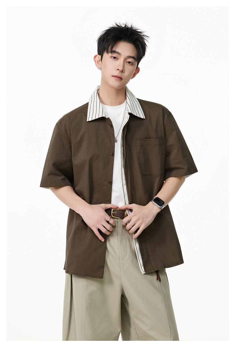 Model wearing a dark brown short-sleeve shirt with a striped collar and single chest pocket.